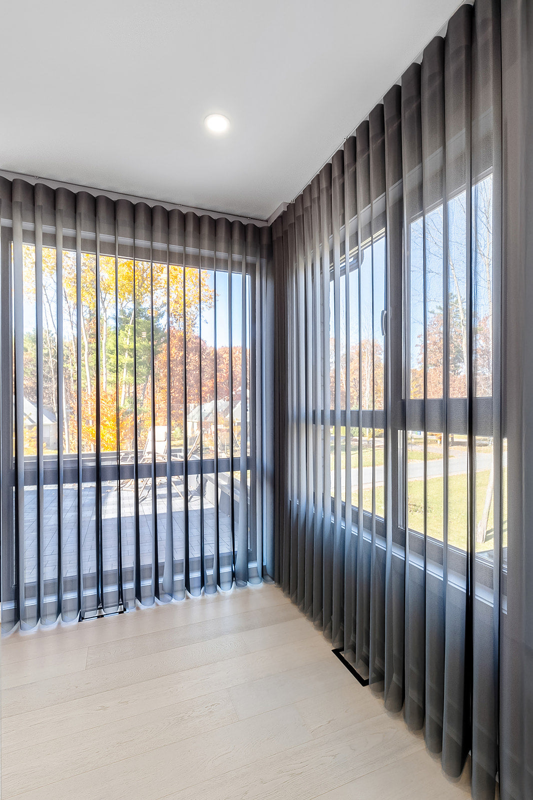 large windows covered  gray curtains